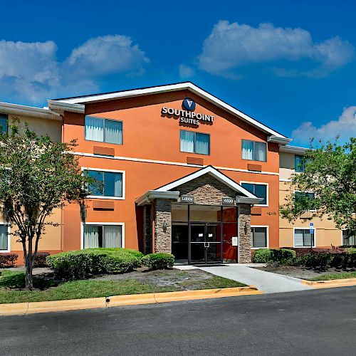 The image shows a hotel building with a sign reading 